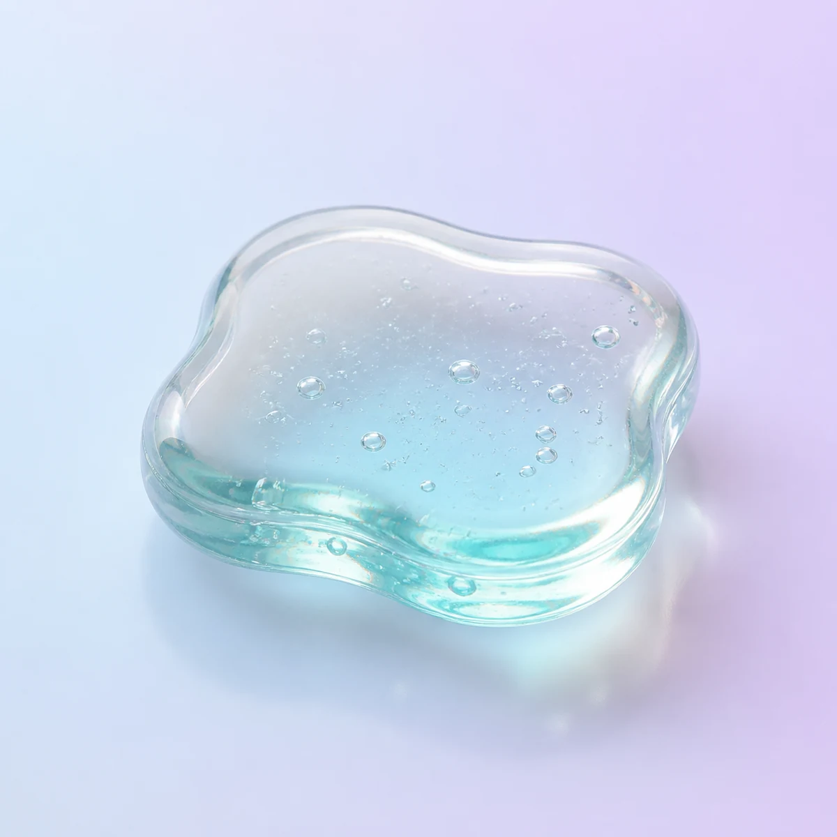 Jelly Blob Transparent Gel Fidget: clear aqua-tinted sealed gel toy on a soft pastel background
