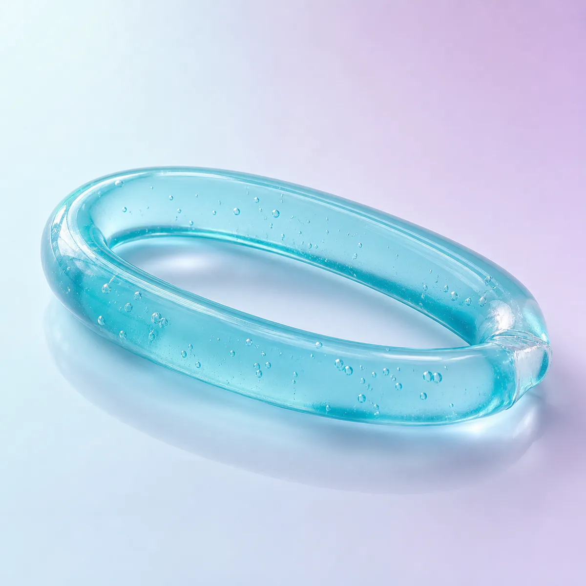 Slip Wiggler Water Snake: translucent aqua gel tube on a soft pastel background